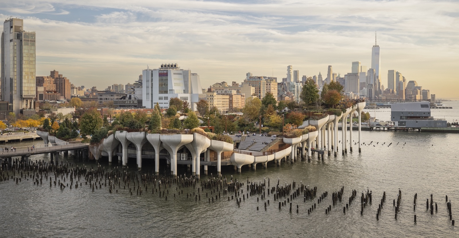 Little Island at golden hour, with the Manhattan skyline behind it